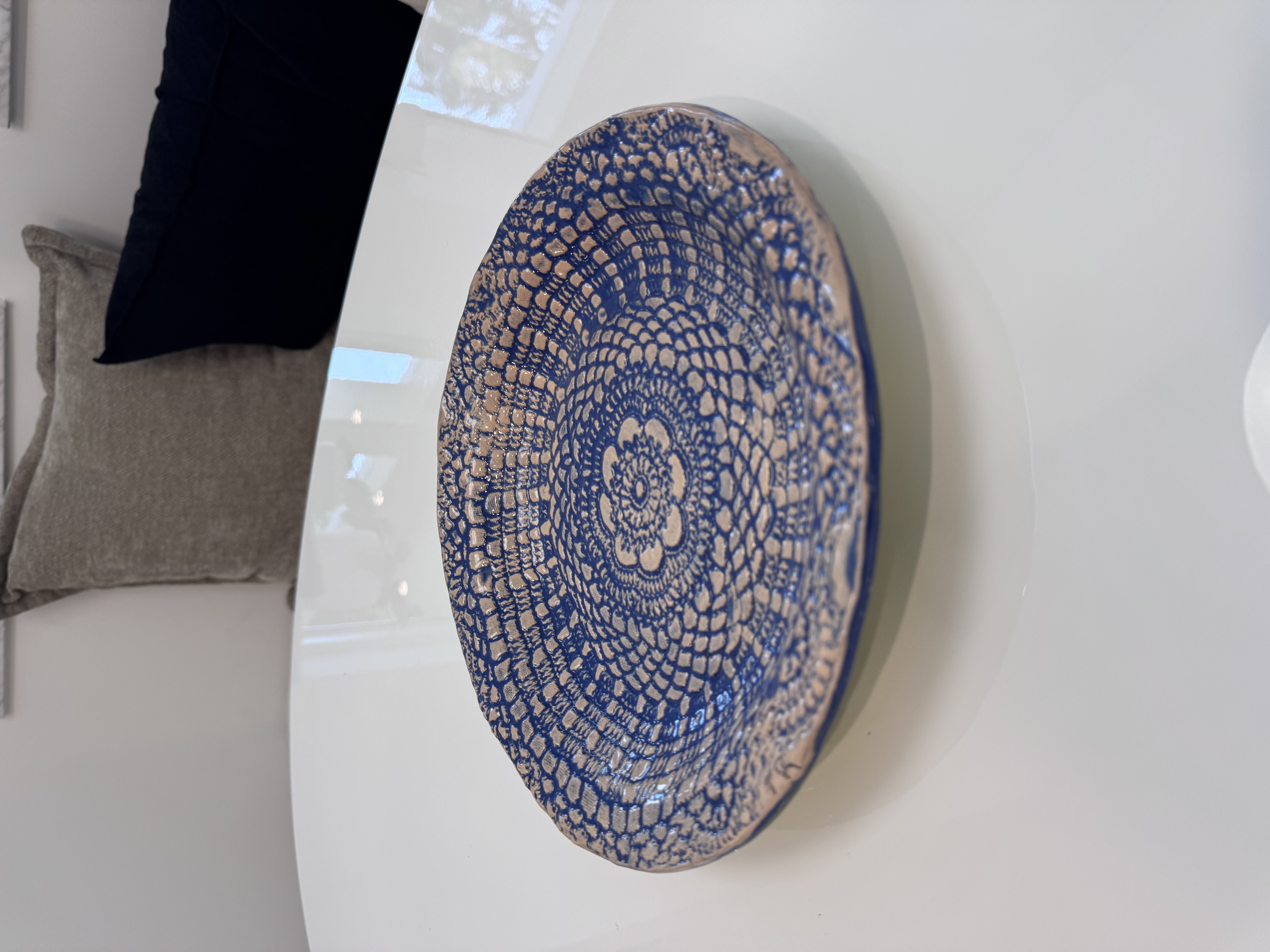 Ceramic plate with intricate blue lace pattern