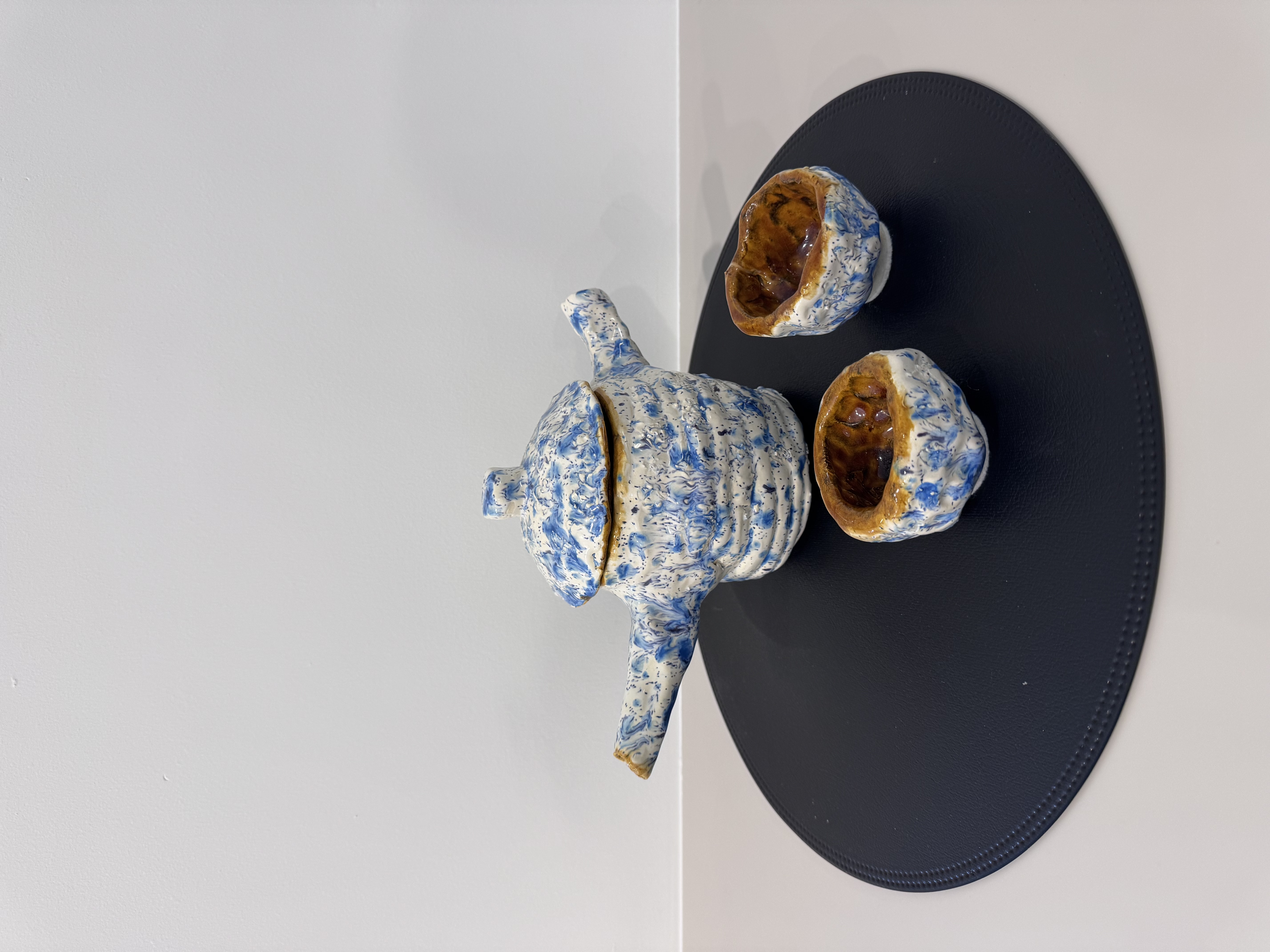 Blue speckled teapot with matching cups, top view